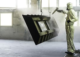 Worker Sandblasting Metal Piece
